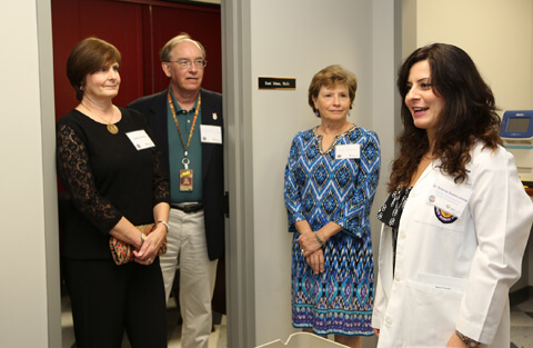 Mrs. Cynthia Glancy along with Dr. & Mrs. Fred Rodriguez listen intently to Erminia Donnarumma, PhD, post-doctorate fellow, explain her role in the Center